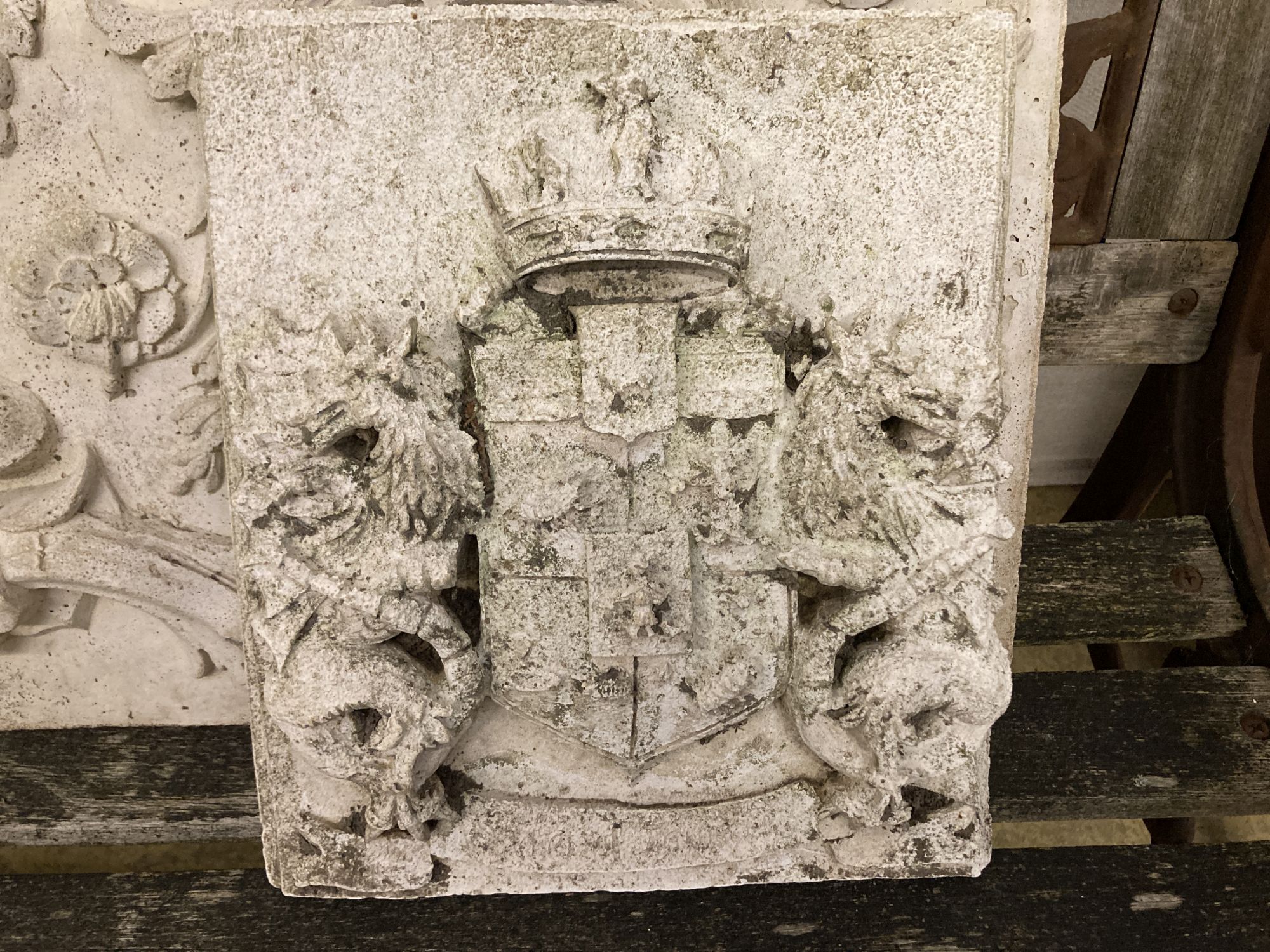 Three reconstituted stone and plaster wall plaques, largest 94 x 40cm